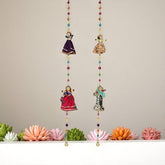 Decorative hanging with colorful beads and small figurines on a neutral background
