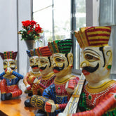 Colorful figurines with intricate designs on a wooden surface.