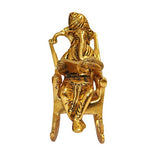 Lord Ganesha Statue Sitting on A Chair And Reading Ramayan