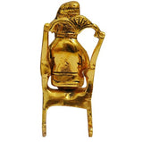 Lord Ganesha Statue Sitting on A Chair And Reading Ramayan