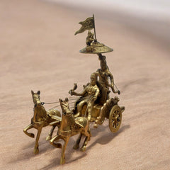 Bronze chariot with horses and figures on a beige background